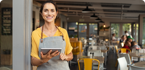 Small business owner at entrance of business